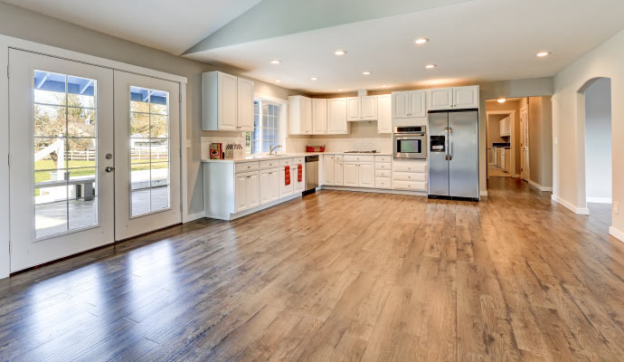 clean laminate floor in a kitchen and livin room area